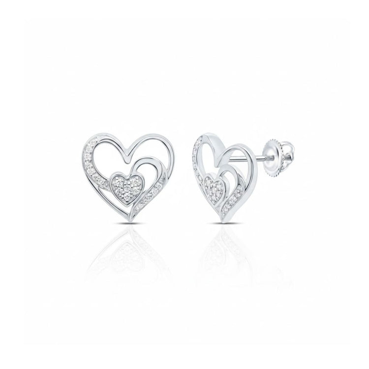 The 1/10 CTW Natural Diamond Heart Earrings are silver, heart-shaped studs with an open heart design and a smaller pavé diamond heart inside. They feature a polished finish and secure post with butterfly backs.