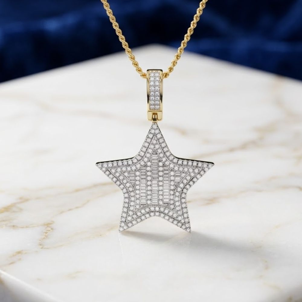 The 14K Gold Diamond Star Charm Pendant 3/4 CTTW necklace shines on a white marble surface, highlighted by its glimmering yellow gold and sparkling diamonds against a blurred dark blue background.