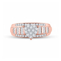 The 10k Gold Round Diamond Heart Engagement Ring features a cluster of diamonds at the center and rows of round and baguette-cut stones on the wide band, creating an elegant heart-shaped design in rose gold.