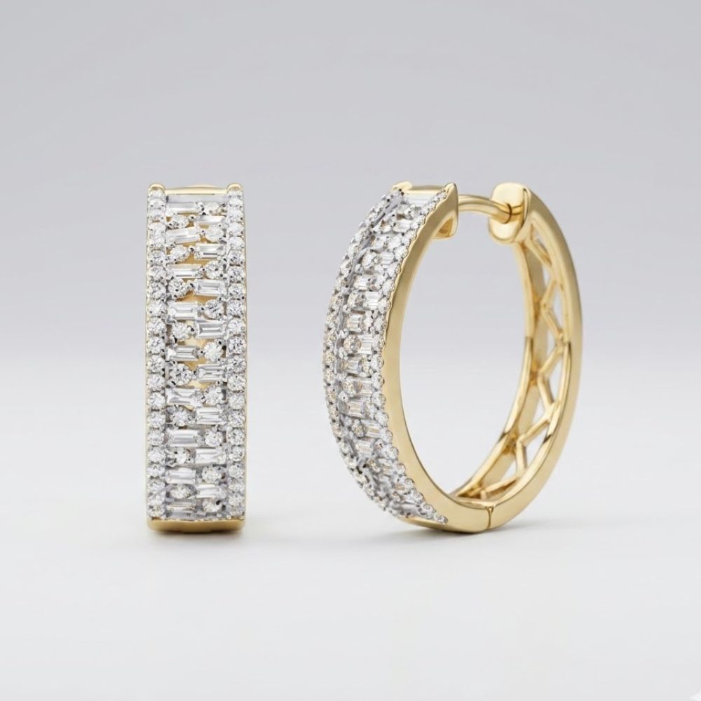 The 14k Gold Baguette Diamond Hoop Earrings 7/8CTW feature multiple rows of sparkling white diamonds and are displayed against a plain, light gray background.