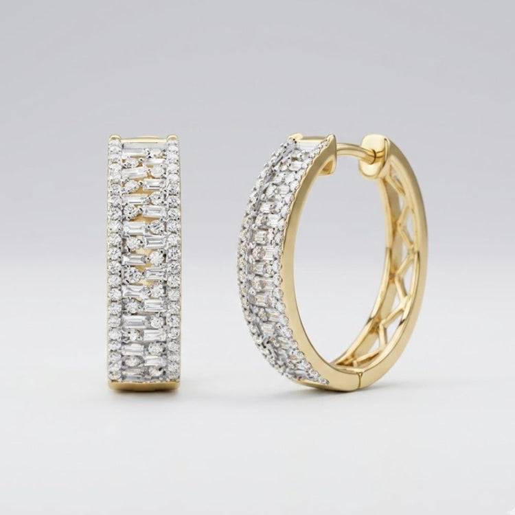 The 14k Gold Baguette Diamond Hoop Earrings 7/8CTW feature multiple rows of sparkling white diamonds and are displayed against a plain, light gray background.