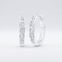 The 10K Diamond Hoop Earrings 1/4 CTTW Gold feature rows of sparkling natural diamonds set in 10K gold, displayed upright against a plain light background.