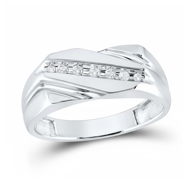The 10k White Gold Diamond Wedding Band 1/8 Cttw features a modern angular design with seven round brilliant diamonds set diagonally, creating an elegant and polished look perfect for any occasion.