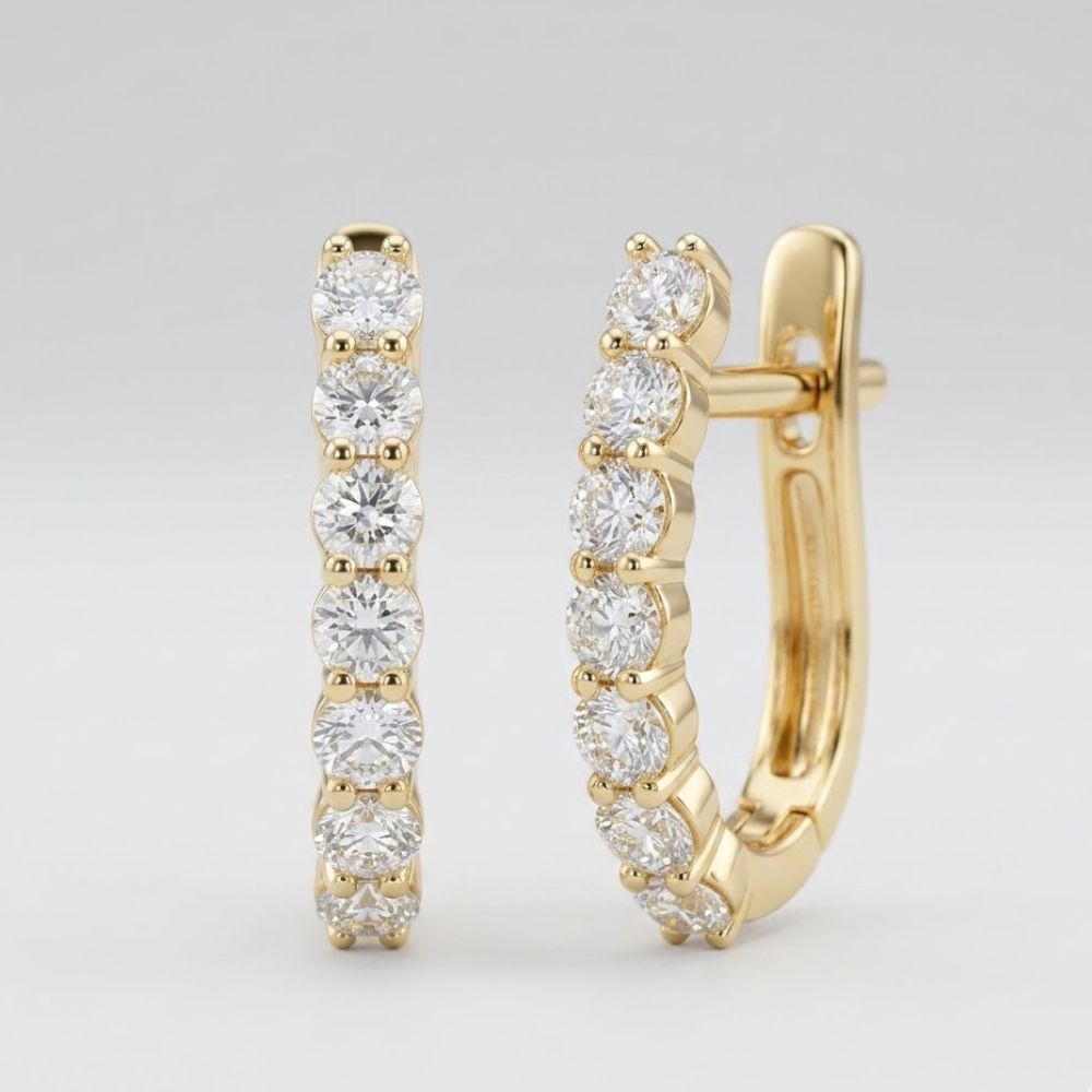 A pair of 10k Gold Diamond Fashion Hoop Earrings 1/2CTW, each encrusted with seven round natural diamonds on the front, displayed against a plain light background.