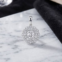 The 10k Gold Diamond Fashion Pendant 3/4 Cttw showcases a dazzling central round diamond encircled by two sparkling rows of smaller diamonds. Displayed on pristine white marble with a touch of black velvet, this chic pendant brings timeless elegance and radiant sparkle to any look.