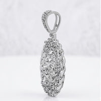The Diamond Lion Face Cuban Charm 1/2CT Sterling Silver showcases a detailed lion’s head bordered by textured silver, set in an oval design and photographed against a soft, blurred white background.