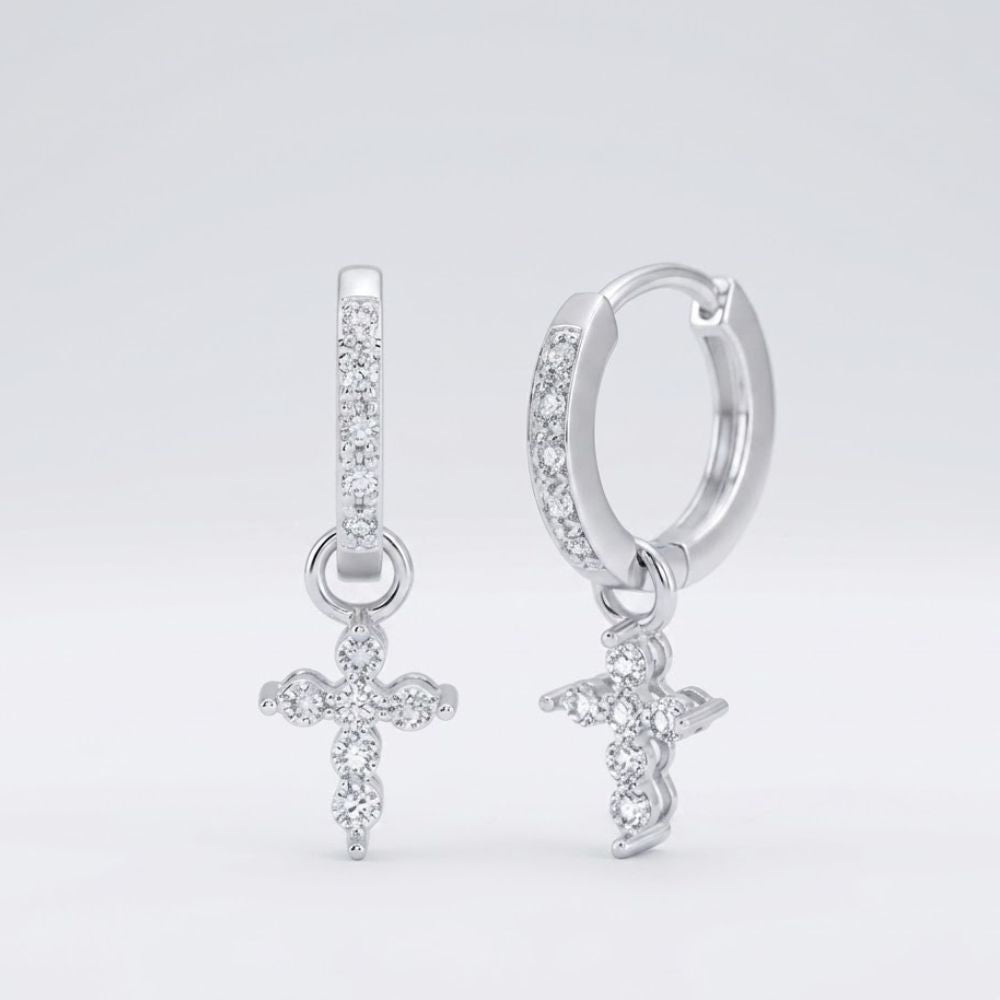 A pair of 10k yellow gold round diamond cross hoop dangle earrings (1/8 cttw), each with a dangling diamond-studded cross charm, displayed against a plain white background.