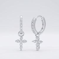 A pair of 10k yellow gold round diamond cross hoop dangle earrings (1/8 cttw), each with a dangling diamond-studded cross charm, displayed against a plain white background.