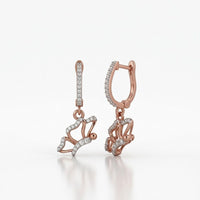 10k Gold Diamond Butterfly Dangle Earrings 1/4 Cttw feature butterfly-shaped designs with sparkling diamonds and extra gems along the hooks, displayed on a white background.