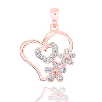 The Diamond Flower Heart Pendant 1/20 CTW in 10K gold features two open hearts, one with sparkling accents, and two flower designs set against a white background.