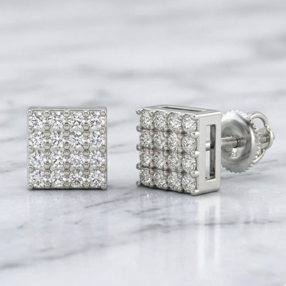 The Sterling Silver Diamond Square Earrings 1/6 Cttw feature grid-like patterns with multiple small diamonds set in square sterling silver, shown on a marble surface.