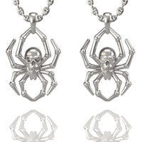 The 14k Gold Spider Skull Pendant features a spider-shaped design with a skull as its body, shown side by side and reflected on a white background—a striking addition to any skull jewelry collection.