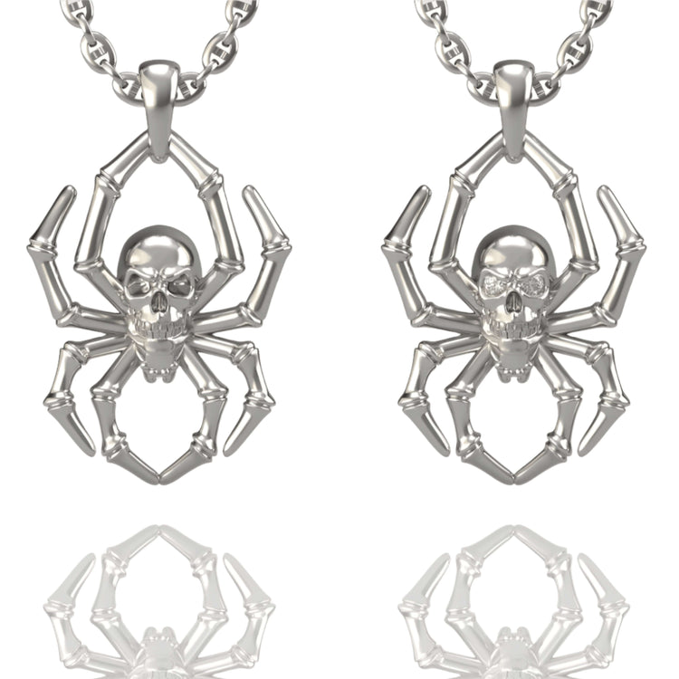 The 14k Gold Spider Skull Pendant features a spider-shaped design with a skull as its body, shown side by side and reflected on a white background—a striking addition to any skull jewelry collection.