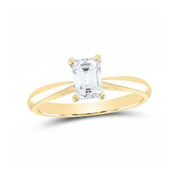 The 3/4CT Emerald Solitaire Ring in 14k Gold features a rectangular emerald-cut clear gemstone set in a split shank band and secured by four prongs.