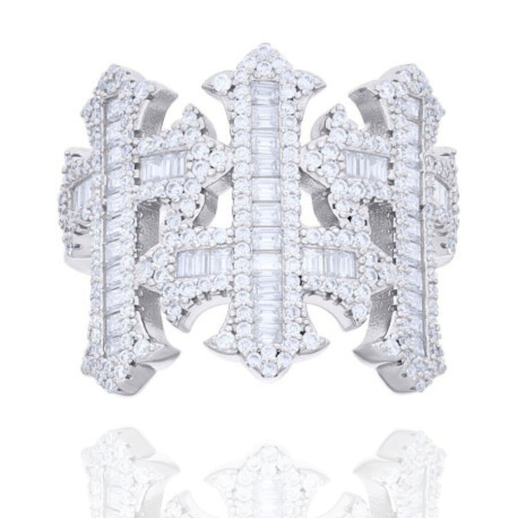 The Baguette Moissanite Cross Religious Ring is a wide silver band with an openwork geometric design, adorned with rows of round and baguette-cut moissanite gemstones for a sparkling, ornate look.