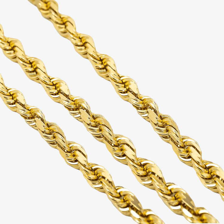 Close-up of three Gold Rope Chains - 7mm, arranged diagonally on a white background. Each chain features twisted, intricate links that create a textured and reflective 14k gold surface.