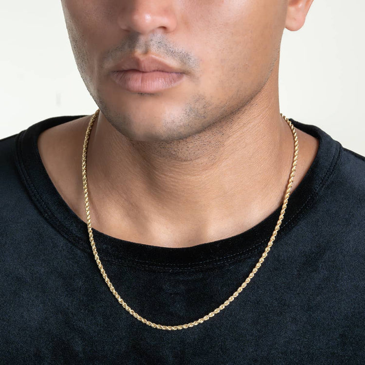 A person wearing a plain black shirt and a 7mm Gold Rope Chain necklace. The image shows their head and upper chest against a light background.