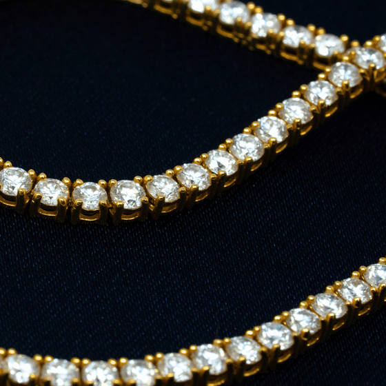 2mm Tennis Chain with 5.89ct Lab Diamonds set in a classic 4 prong setting crafted from 14k Solid Yellow Gold. Secured with a traditional box lock.  