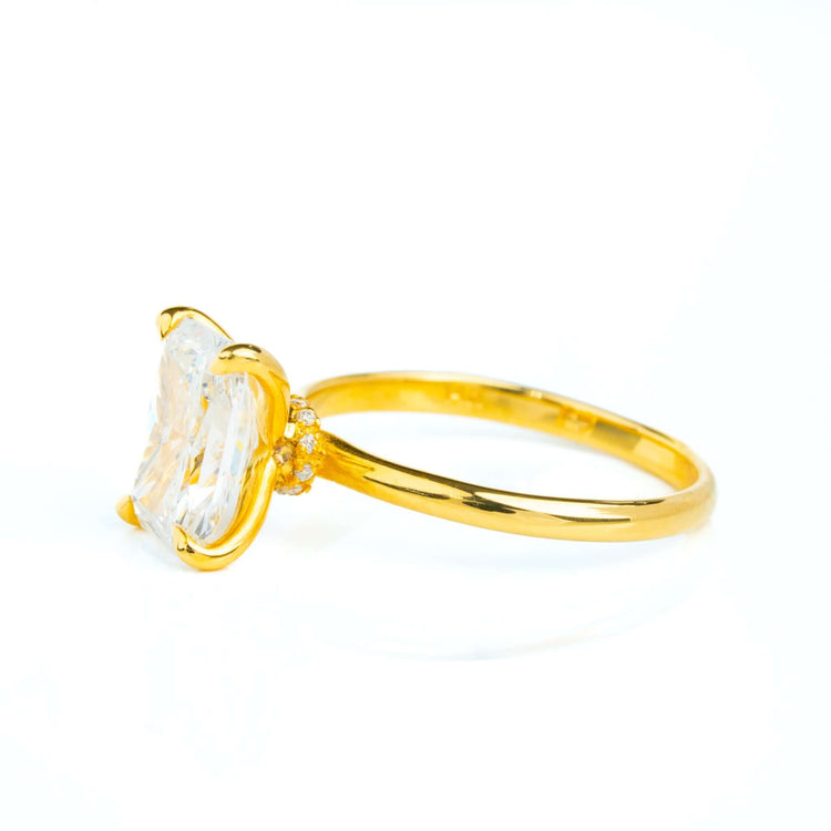 The 3.01ct Radiant Lab Diamond Solitaire Engagement Ring in 14k solid yellow gold features a radiant-cut lab-grown diamond in a four-prong setting, accented by small round diamonds on the band, shown against a white background.