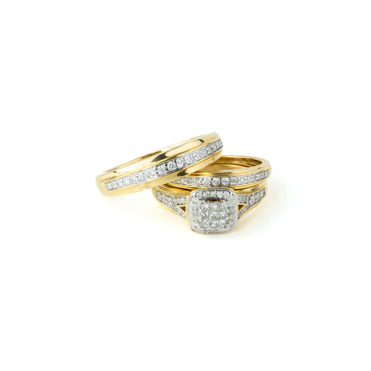 A 3/4 CTW 10k Yellow Gold Wedding Trio Set is pictured, featuring a princess-style diamond engagement ring with a square cluster and a matching wedding band, both displayed on a plain white background.