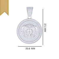 The Moissanite Medusa Egyptian Charm Pendant features a round sterling silver design with a Medusa face, sparkling clear stone accents, and measures 37.1 mm tall by 25.6 mm wide, set on a white background with a tan ribbon in the upper left.