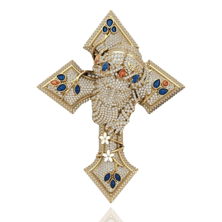 The Diamond Jesus Head Pendant with Sapphire and Ruby Accents showcases a detailed, diamond-encrusted face highlighted by sapphire and ruby accents, with intricate floral vine motifs in 14K gold on a white background.