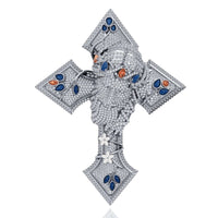 The Diamond Jesus Head Pendant with Sapphire and Ruby Accents features a sculpted diamond-encrusted face, highlighted by sapphire and ruby accents, plus white gemstones in leaf and flower motifs.