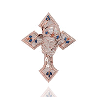 The Diamond Jesus Head Pendant features sparkling white and blue stones with sapphire and ruby accents, designed as a jeweled cross showcasing a detailed Jesus head at the center, set against a white background.