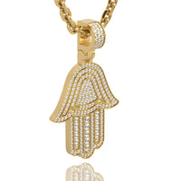 The 14k Gold Hamsa Hand Pendant with Diamonds features a Hamsa-shaped pendant adorned with sparkling diamonds, hanging elegantly from a gold chain.