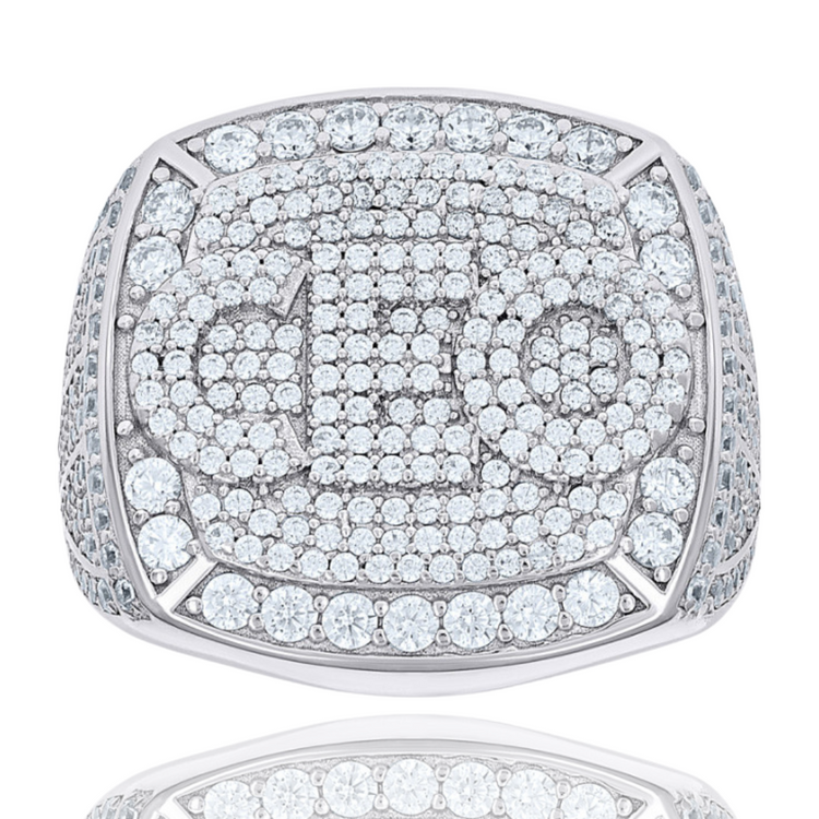 The Baguette Moissanite CEO Square Head Fashion Ring features a bold geometric pattern on the face and sides, encrusted with sparkling moissanites atop a reflective surface.