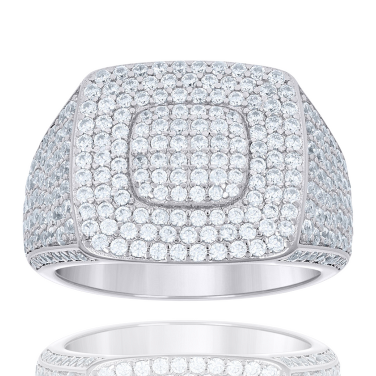 The Moissanite Square Head Fashion Ring features a wide silver band and a square-shaped top adorned with sparkling moissanite stones, creating a bold, modern statement piece. Its luxurious design is beautifully reflected below.