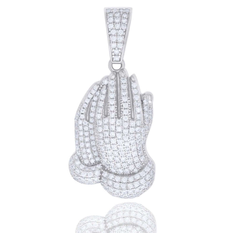 The 925 Silver Moissanite Praying Hands Charm showcases two hands joined in prayer, encrusted with sparkling gemstones, crafted in silver for an elegant and meaningful accessory.