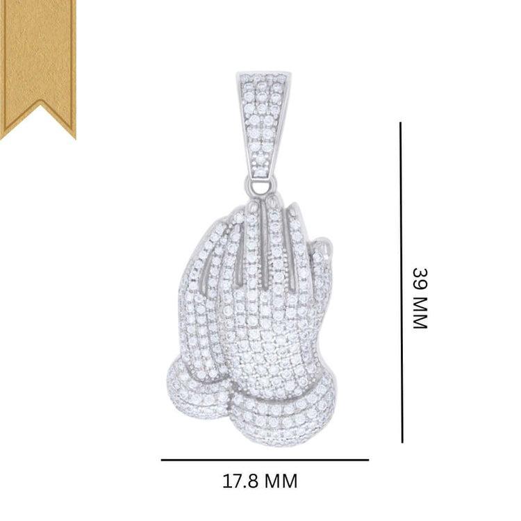 The 925 Silver Moissanite Praying Hands Charm is a pendant shaped like praying hands, set with white stones and topped with a gold ribbon. It measures 39mm tall by 17.8mm wide.