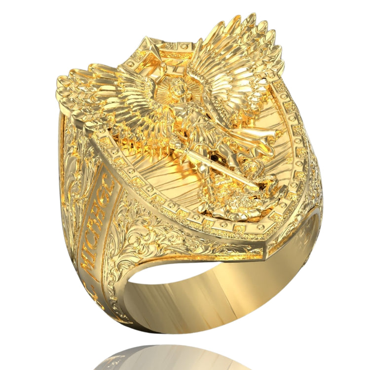 A detailed men's gold ring with an engraved shield, a three-dimensional eagle, ornate side patterns, and "MICHEG" inscribed—perfect as the Gold Archangel Michael Ring with Dragon.