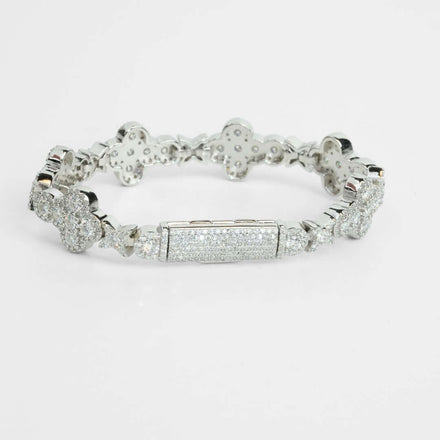 The Moissanite Cross Fancy Bracelet is a 925 sterling silver piece with flower-shaped links and a rectangular centerpiece, embellished with sparkling stones, shown on a white background.