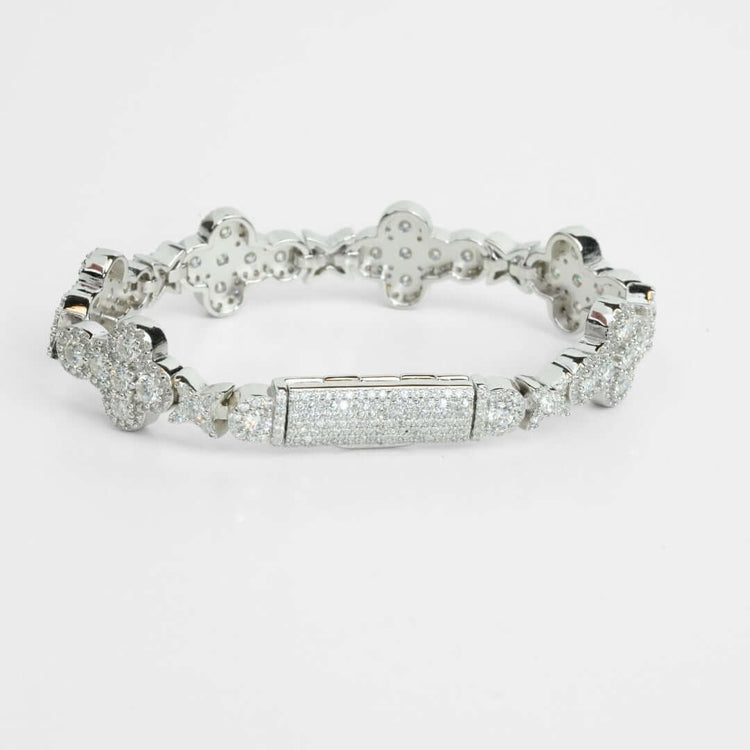 The Moissanite Cross Fancy Bracelet is a 925 sterling silver piece with flower-shaped links and a rectangular centerpiece, embellished with sparkling stones, shown on a white background.