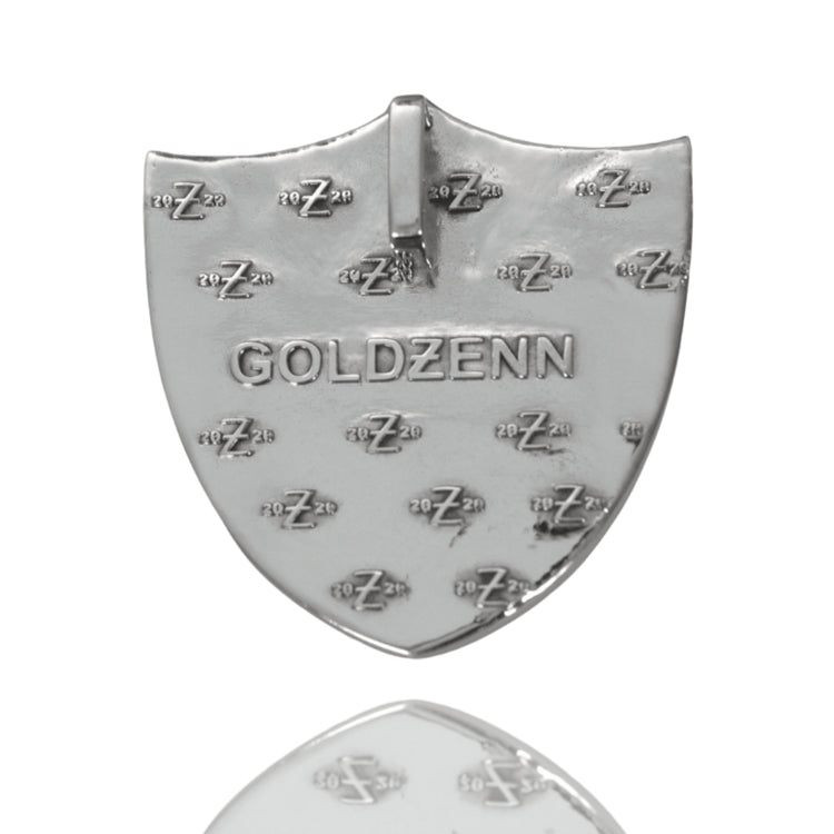 A shiny, shield-shaped Raiders Custom Pendant Moissanite in 14K White Gold with "GOLDZENN" engraved at the center and multiple small "zZz 2023" imprints, shown on a white background.