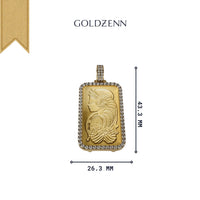 The 24K Suisse 1 Oz Gold Bar Pendant features a rectangular gold design (43.3 x 26.3 mm) with an engraved woman and fish, gemstone border, and the GOLDZENN name above—elegantly inspired by classic PAMP Suisse artistry.