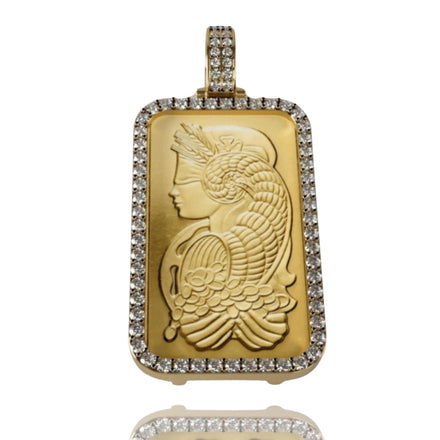 The 24K Suisse 1 Oz Gold Bar Pendant showcases a rectangular gold bar engraved with a detailed female profile, framed by sparkling diamond accents and a diamond-encrusted bail.