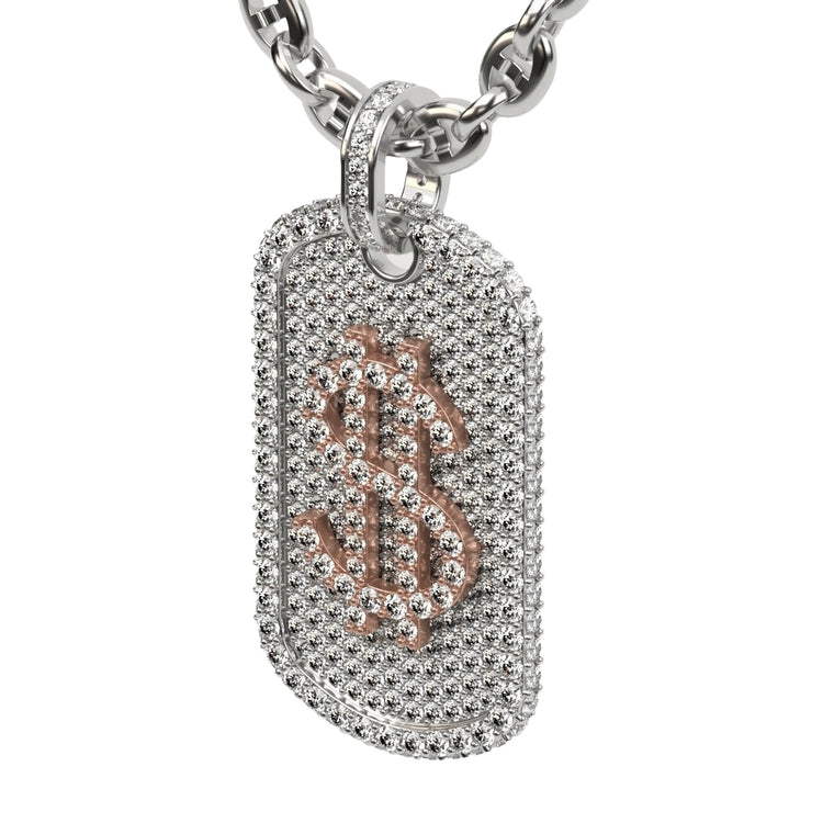 The 14K Diamond Dollar Sign Dog Tag Pendant features a silver dog tag encrusted with natural diamonds and a rose gold dollar sign ($) at the center, hanging from a chunky silver chain—a truly stunning jewelry piece.