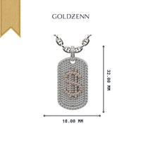 The 14K Diamond Dollar Sign Dog Tag Pendant features a silver chain and a rectangular gold dog tag with natural diamonds and a rose gold dollar sign, measuring 32.00 mm by 18.00 mm, with the Goldzenn logo above.
