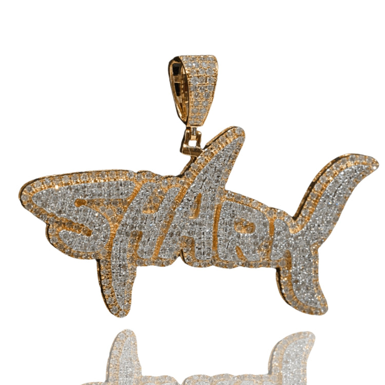 The Shark Diamond Pendant – 14K Gold features a shark-shaped design with diamond accents and "Shark" on its body, plus a textured gold bail—a bold, eye-catching pendant for men.
