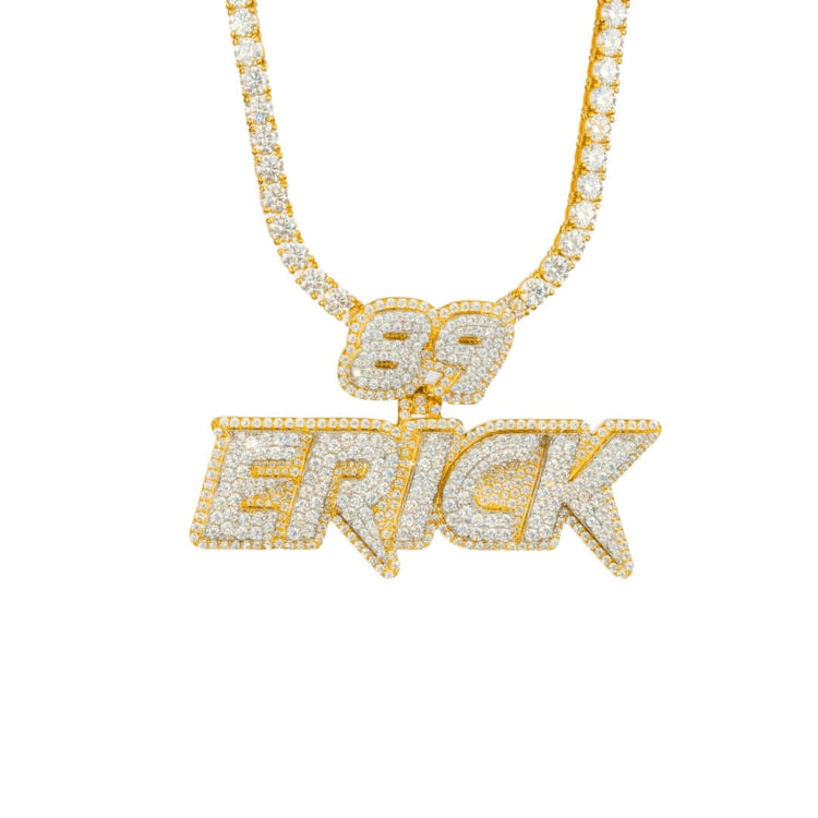 The Custom Diamond Name Pendant - Solid Yellow Gold features a personalized "89 ERICK" nameplate in all caps, encrusted with diamonds and hanging from a matching diamond-studded chain against a white background.
