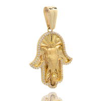 The Hamsa Hand Pendant - 10k is a gold piece engraved with an eye and sunburst design, bordered by clear zircon stones. Its polished finish and large bail make it easy to attach to your favorite chain.
