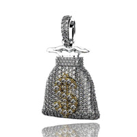 The Diamond Money Bag Pendant - 14k features gold and silver stones with a gold dollar sign and silver clasp, sparkling as it reflects elegantly on a white surface.
