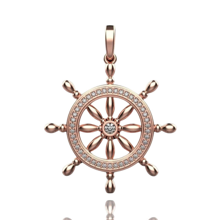 The Nautical Ship Wheel Pendant - 14k features a rose gold finish, diamond-studded circular frame, central gemstone, eight spokes, and a top loop—an elegant nautical jewelry piece for any necklace.
