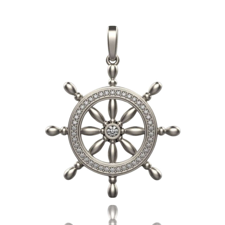 The Nautical Ship Wheel Pendant - 14k features a silver ship wheel with a central gemstone, a circle of sparkling stones, eight spokes, and a bail—perfect nautical jewelry for maritime style lovers.