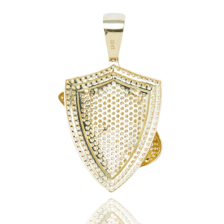 The Shark Pendant in 10k Gold with CZ, a men’s gold pendant, features a detailed shark design with sparkling CZ stones and a loop for attaching to a chain. This striking piece is presented on a white background.