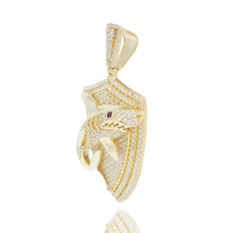 The Shark Pendant in 10k Gold with CZ for men features a three-dimensional open-mouth shark encrusted with cubic zirconia, set on a shield-shaped background sparkling with clear stones.