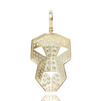 The Edge Mask Pendant in 10k solid gold features a bold geometric mask design with cut-out sections and circular indentations, making it a striking men's pendant with modern appeal.